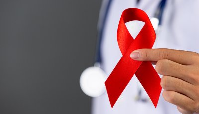 The doctor holds a red ribbon, HIV awareness awareness, World AIDS Day and World Sexual Health Day.