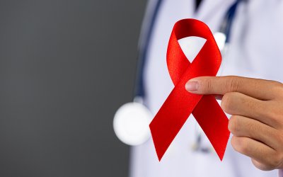 The doctor holds a red ribbon, HIV awareness awareness, World AIDS Day and World Sexual Health Day.