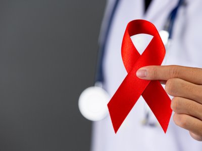 The doctor holds a red ribbon, HIV awareness awareness, World AIDS Day and World Sexual Health Day.
