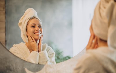 Woman at home applying cream mask