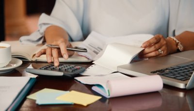Hands of female entrepreneur working with bills and documents